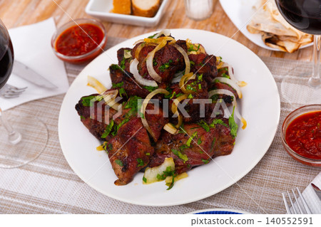 Barbecued pork shashlik with onion and herbs 140552591