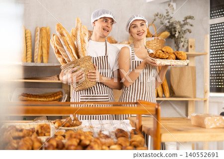 Young sellers standing in bake house, ready to greet customers Young sellers standing in bake house, ready to greet customers 140552691