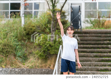 A female student in gym clothes taking an oath at a sports festival A female student in gym clothes taking an oath at a sports festival 140552725