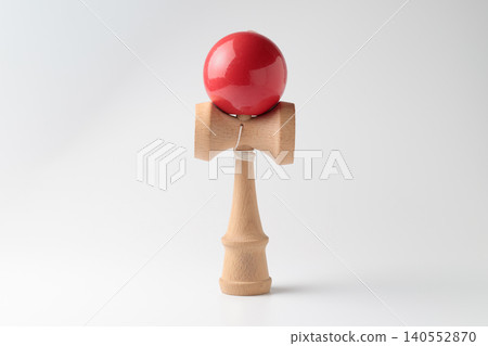 A traditional wooden kendama (cup-and-ball game) standing upright against a white background. A traditional wooden kendama (cup-and-ball game) standing upright against a white background. 140552870