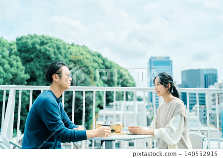 A couple enjoying coffee on their balcony A couple enjoying coffee on their balcony 140552915