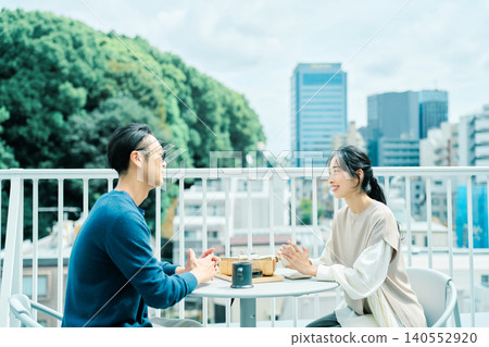 A couple enjoying coffee on their balcony A couple enjoying coffee on their balcony 140552920
