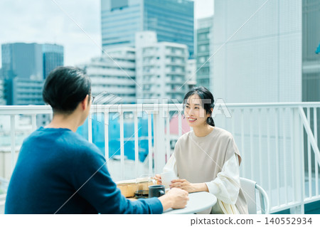 一對夫婦在陽台上享用咖啡 一對夫婦在陽台上享用咖啡 140552934