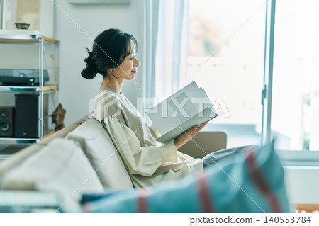 Woman relaxing in the living room 140553784