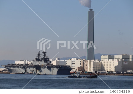 America-class amphibious assault ship and factory docked in Osaka Port America-class amphibious assault ship and factory docked in Osaka Port 140554319