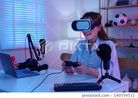 Asian woman playing VR gaming with virtual reality headset and controller for technology entertainment Asian woman playing VR gaming with virtual reality headset and controller for technology entertainment 140554531