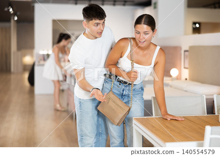 Couple man and woman choosing table in store Couple man and woman choosing table in store 140554579