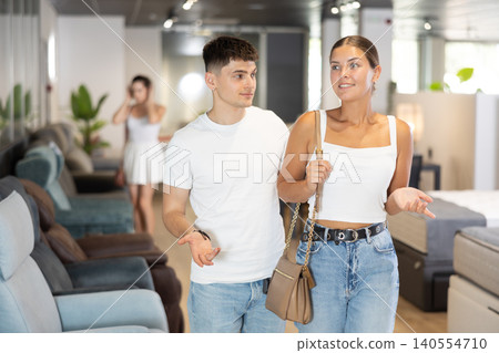 Couple man and woman looking around in furniture store 140554710