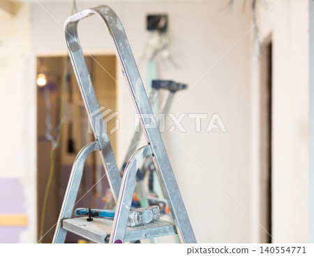 Stepladder in middle of a room under renovation in house Stepladder in middle of a room under renovation in house 140554771