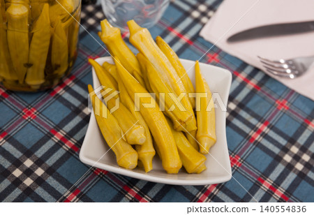 Pickled okra pods on plate, homemade preserves Pickled okra pods on plate, homemade preserves 140554836
