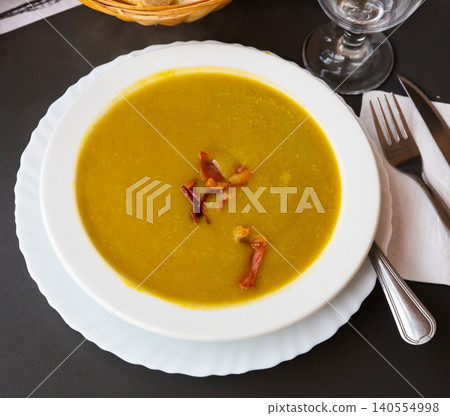Cream soup of vegetables garnished with gammon slices Cream soup of vegetables garnished with gammon slices 140554998