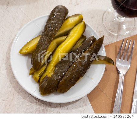 Sliced pickled cucumbers on plate Sliced pickled cucumbers on plate 140555264