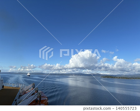 A panoramic view of the blue sky and sea from a cruise ship overlooking the Norwegian fjords. A panoramic view of the blue sky and sea from a cruise ship overlooking the Norwegian fjords. 140555723
