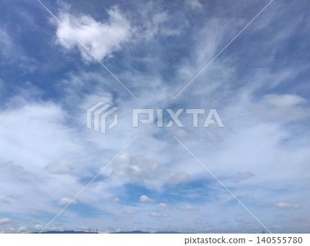 A vast blue sky with white clouds drifting gently by. A vast blue sky with white clouds drifting gently by. 140555780