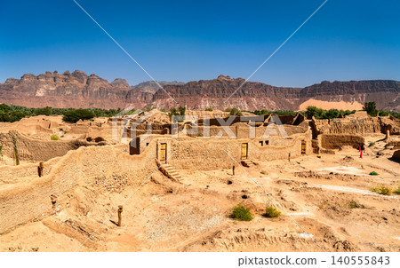 Panoramic view of the ancient mud brick ruins of AlUla Old Town with mountains in the background, Saudi Arabia. Panoramic view of the ancient mud brick ruins of AlUla Old Town with mountains in the background, Saudi Arabia. 140555843