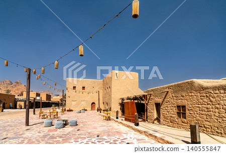 Outdoor seating area with hanging lanterns among the historic mud brick buildings and traditional architecture of AlUla Old Town in Saudi Arabia Outdoor seating area with hanging lanterns among the historic mud brick buildings and traditional architecture of AlUla Old Town in Saudi Arabia 140555847