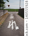 A stop sign on a country road leads to a peaceful Japanese intersection. 140555928