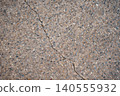 Cracked exposed aggregate concrete: the texture of the ground possesses a beauty in its imperfection. 140555932