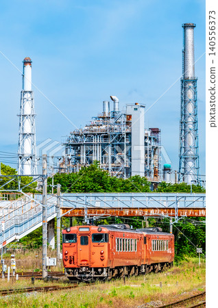 Iwakuni Line: A reddish-brown Kiha 40 train runs with an oil refinery in the background, near Kushigahama Station. Iwakuni Line: A reddish-brown Kiha 40 train runs with an oil refinery in the background, near Kushigahama Station. 140556373