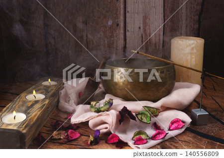 Singing bowl and candles creating a relaxing atmosphere for meditation Singing bowl and candles creating a relaxing atmosphere for meditation 140556809