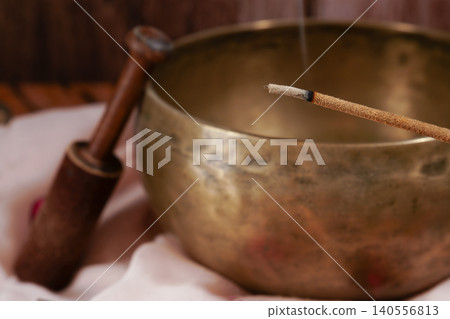 Burning incense stick with singing bowl and mallet Burning incense stick with singing bowl and mallet 140556813
