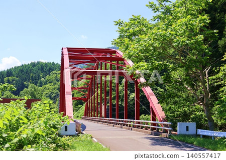 Red steel bridge near Shimoyu Dam 140557417