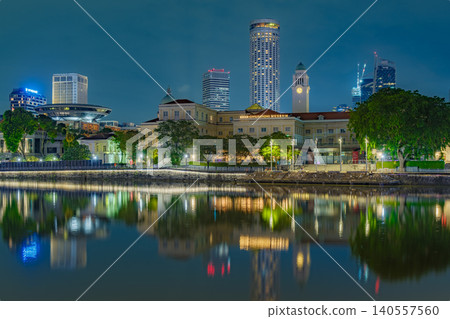 Singapore City Skyline and Historical Buildings Reflected in Singapore River at Night with Skyscraper Background 140557560