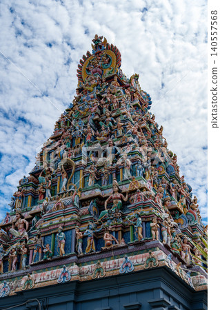 Ornate gopuram of Sri Mariamman Temple in Singapore showcasing intricate and colorful carvings of Hindu deities and mythological figures in detail Ornate gopuram of Sri Mariamman Temple in Singapore showcasing intricate and colorful carvings of Hindu deities and mythological figures in detail 140557568