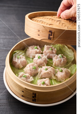 Homemade shumai steamed in a bamboo steamer Homemade shumai steamed in a bamboo steamer 140557675