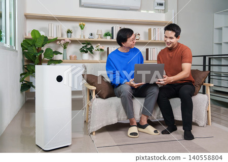 Asian senior man and young man using laptop with smart air purifier at home Asian senior man and young man using laptop with smart air purifier at home 140558804