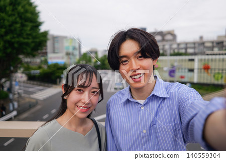 A young couple smiling and taking a selfie. A young couple smiling and taking a selfie. 140559304