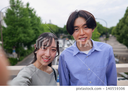A young couple smiling and taking a selfie. A young couple smiling and taking a selfie. 140559306