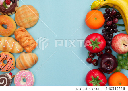 Healthy fresh fruits contrasting with unhealthy sweet pastries 140559516