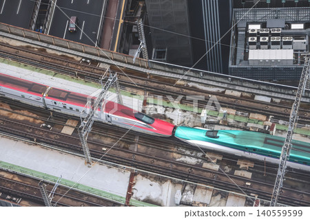 April 29 2026 Red bullet train passing through urban tracks April 29 2026 Red bullet train passing through urban tracks 140559599