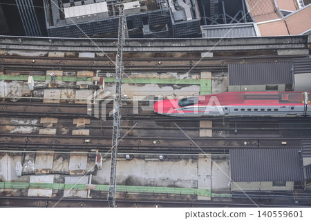 April 29 2026 Red bullet train passing through urban tracks April 29 2026 Red bullet train passing through urban tracks 140559601