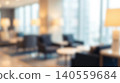 Blurred modern luxury hotel lobby interior featuring comfortable armchairs illuminating lamps near large windows creating bright relaxing corporate waiting room business background 140559684
