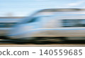 Abstract dynamic horizontal motion blur showing modern silver high speed passenger train rushing forward expressing rapid transport travel technology transit progress concept 140559685