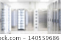 Blurred bright modern data center room featuring metal server racks containing digital internet computing hardware creating abstract tech cyber web hosting background 140559686