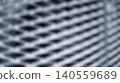 Abstract blurred metallic wire mesh texture featuring diagonal grid pattern creating dark industrial construction background for modern creative graphic design digital projects 140559689