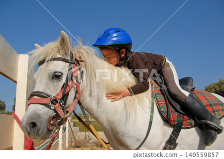 riding child and pony riding child and pony 140559857