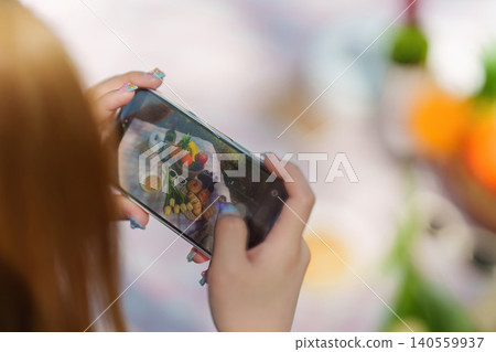 Asian woman taking food photography for social media content at spring outdoor picnic Asian woman taking food photography for social media content at spring outdoor picnic 140559937