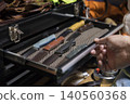 A hunter's hand holding a hunting knife. 140560368