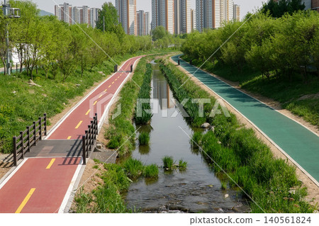 Urban ecological river with walkway and bicycle path Urban ecological river with walkway and bicycle path 140561824