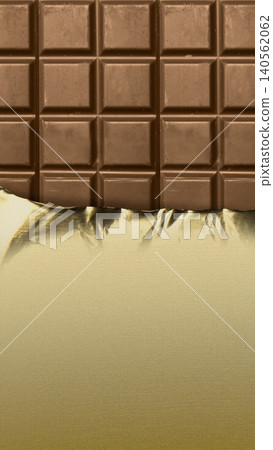 A vertical close-up of a classic milk chocolate bar, partially unwrapped from its elegant gold foil packaging A vertical close-up of a classic milk chocolate bar, partially unwrapped from its elegant gold foil packaging 140562062