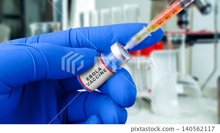 Close-up of a gloved hand holding an Ebola vaccine vial with a syringe in a lab Close-up of a gloved hand holding an Ebola vaccine vial with a syringe in a lab 140562117