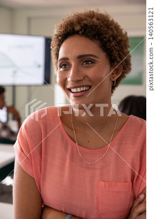 Diverse coworkers watching African American woman presenting graph on display monitor in classroom 140563121