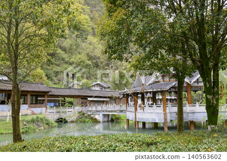 Gazebo on the pond and gallery in the Yellow Dragon Park in the mountains near Zhangjiajie, China Gazebo on the pond and gallery in the Yellow Dragon Park in the mountains near Zhangjiajie, China 140563602
