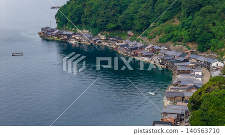 A townscape of boathouses spreads out in a quiet cove. A townscape of boathouses spreads out in a quiet cove. 140563710