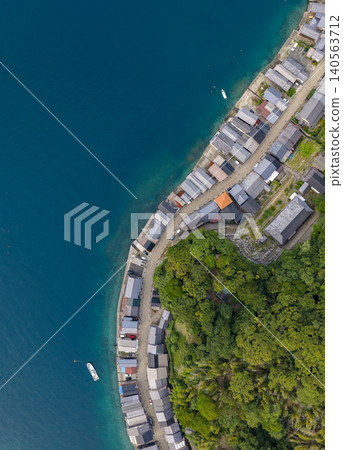 The boathouses of Ine stretch along the blue sea. The boathouses of Ine stretch along the blue sea. 140563712