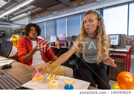 Diverse coworkers celebrating birthday in office with Happy Birthday 30 sign, cupcakes and balloons Diverse coworkers celebrating birthday in office with Happy Birthday 30 sign, cupcakes and balloons 140564629